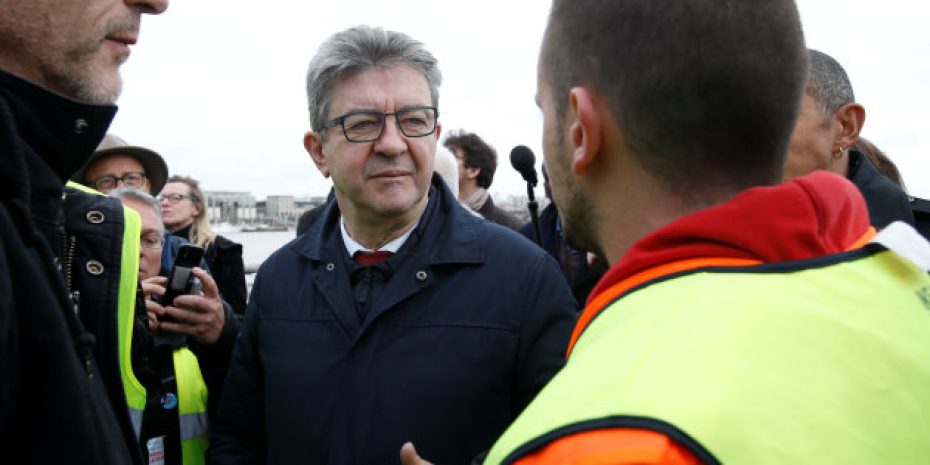 Jean-Luc Melenchon, leader of the far-left opposition France Insoumise (France Unbowed) political party, talks with a protester wearing a yellow vest as they attend a demonstration to urge politicians to act against climate change in Bordeaux, France, as the COP24 is held in Poland, December 8, 2018.  REUTERS/Regis Duvignau